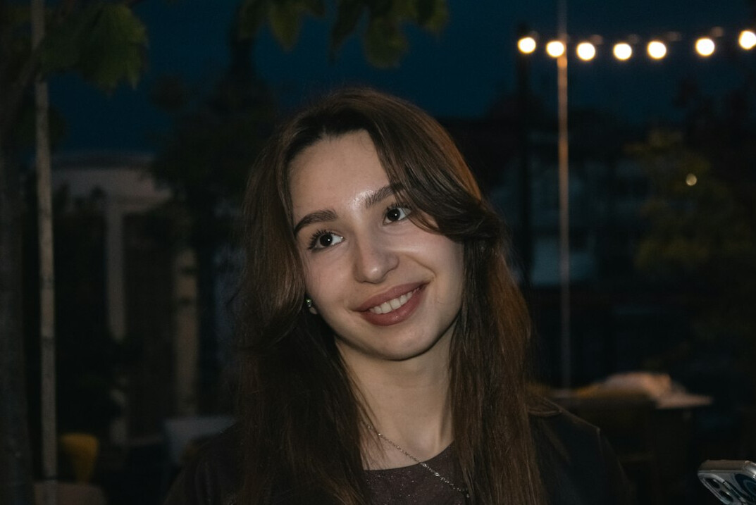 Portrait of a smiling Turkish woman with long dark hair